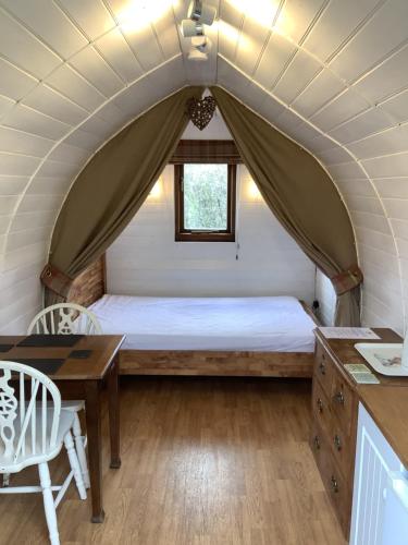 a bedroom with a bed in a tent at Wharfe Camp Glamping in Kettlewell