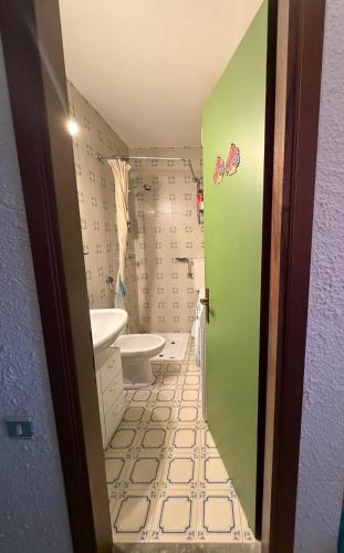 a bathroom with a toilet and a sink at Casa Vacanze S&B in Viola