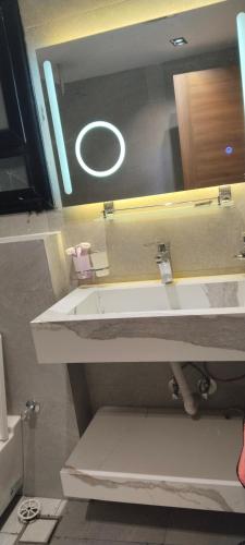 a bathroom with a sink and a mirror at شارع الاربعين حديقه بدر in Cairo