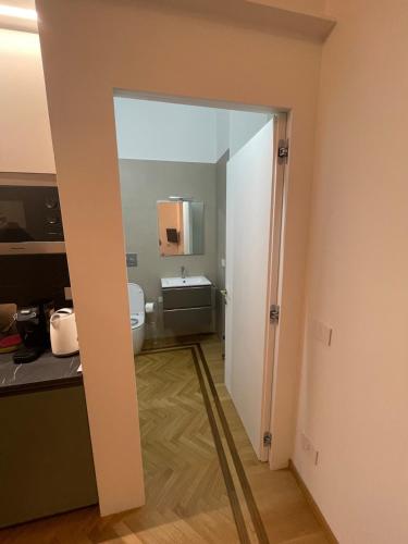 a bathroom with a sink and a toilet in a room at Casa Ferrara in Novara
