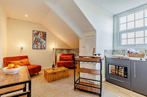 a living room with a couch and a fireplace at 1605 by the sea in Falmouth