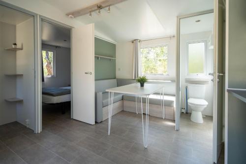a bathroom with a white table and a toilet at Camping Ridaura in Llagostera