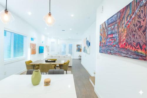 a room with a table and a large painting on the wall at Elite Galleria Luxe World Cup in Houston