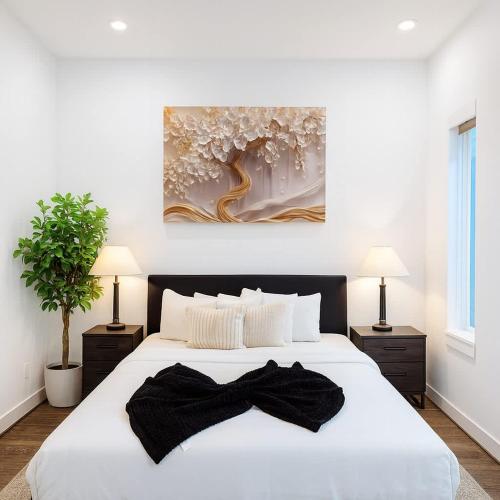 a bedroom with a large white bed with two lamps at Elite Galleria Luxe World Cup in Houston