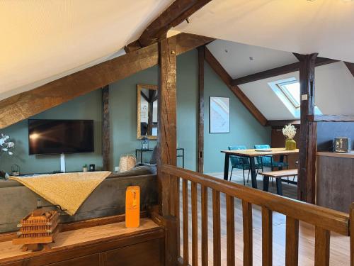 a view of a living room and dining room with a loft at LE CHAMPENOIS-Appartement central près de l' Avenue de Champagne in Épernay