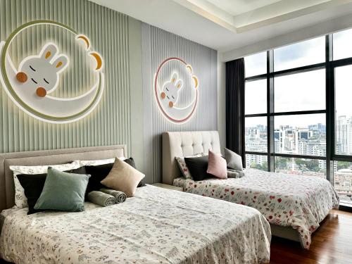 two beds in a bedroom with windows and two bedsitures at Azure Residences, PJ Paradigm By Kiddie Space, Kids Friendly in Petaling Jaya
