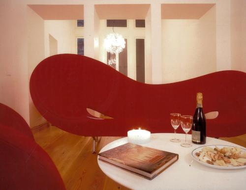a table with a bottle of wine and wine glasses at Palazzo Cicala in Genoa