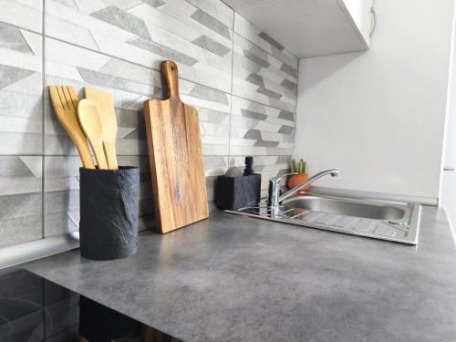 a kitchen counter with a sink and wooden utensils at Alma Del Sur Tenerife in Arona