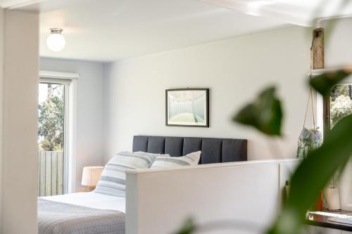 a bedroom with a bed and a window at Secret Spot - Bruny Island in Lunawanna