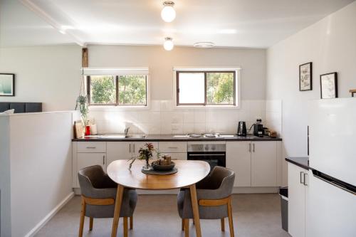 a kitchen with a table and chairs in a room at Secret Spot - Bruny Island in Lunawanna