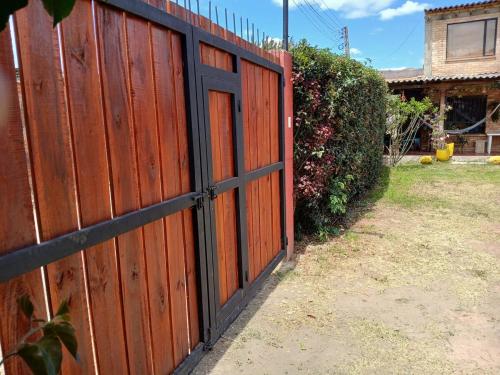 a wooden fence with a door in a yard at Casa Oliva in Sáchica