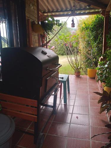 a grill sitting on a patio with a bench at Casa Oliva in Sáchica