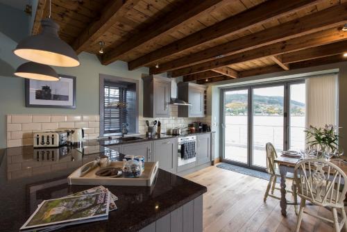 a kitchen with a counter and a table with chairs at Tangle Tower in Inverness