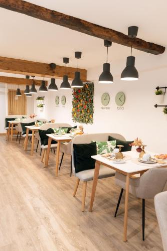 a dining room with tables and chairs and lights at Bellu Suites in Guimarães