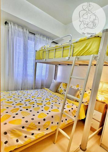 a bedroom with two bunk beds with a yellow bedspread at The Turianos in Manila