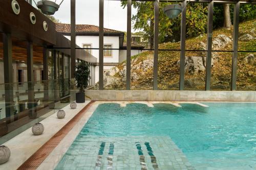 a swimming pool in the middle of a building at Blau Gran Hotel Las Caldas, a member of Radisson Individuals in Las Caldas