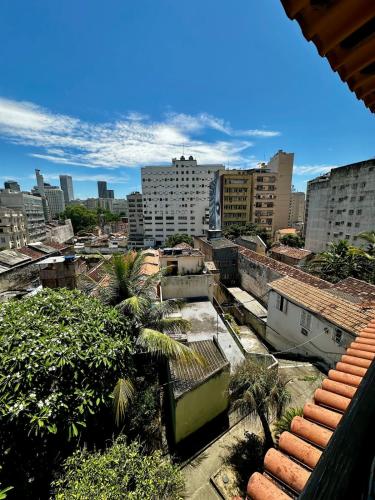 a view of a city with buildings and palm trees at Casa Selarón - Lapa centro in Rio de Janeiro