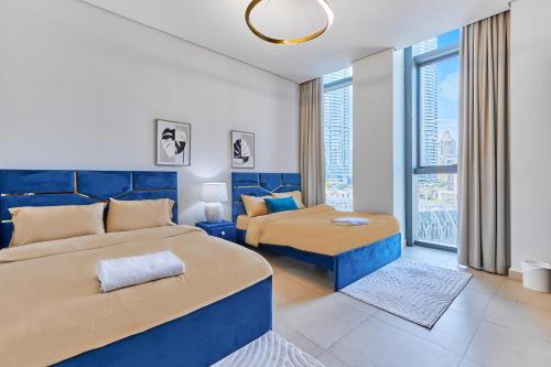 a bedroom with two beds and a living room at Burj Khalifa View Apartments, Burj Vista Tower - Downtown in Dubai