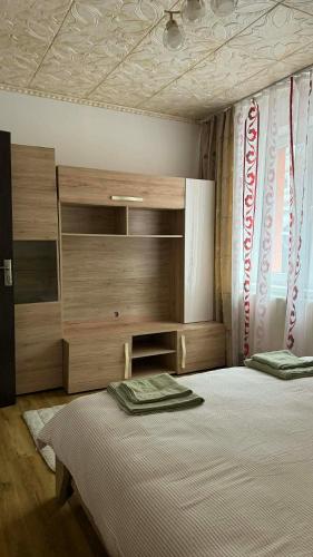 a bedroom with a large bed with a wooden headboard at Sylvia Residence in Lupeni
