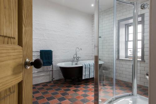 a bathroom with a bath tub and a shower at Tangle Tower in Inverness