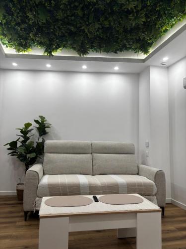 a living room with a couch and a table at Appart'Hôtel 23 Le Cocon Creusois Studio in Guéret