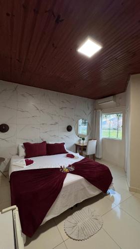 a bedroom with a large bed with red pillows at Mirante Pai Inácio in Lençóis