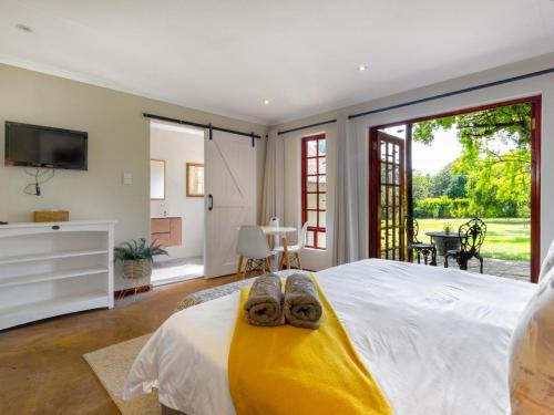 a bedroom with a bed with a pair of shoes on it at The Horseshoe Guesthouse in Midrand