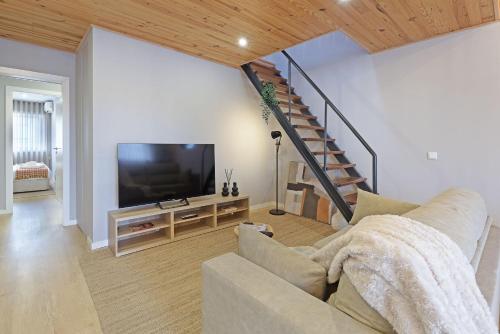 a living room with a couch and a flat screen tv at ON Apartments - Family - Free Parking & Pet Friendly in Porto