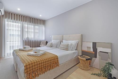 a bedroom with a large bed with a yellow blanket on it at ON Apartments - Family - Free Parking & Pet Friendly in Porto
