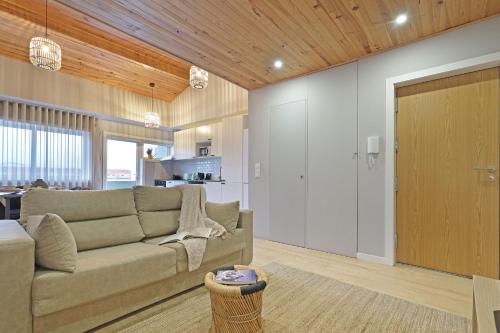 a living room with a couch and a kitchen at ON Apartments - Family - Free Parking & Pet Friendly in Porto