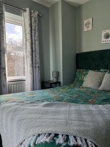 a bedroom with a bed and a window at StoneHaven Townhouse in Donegal