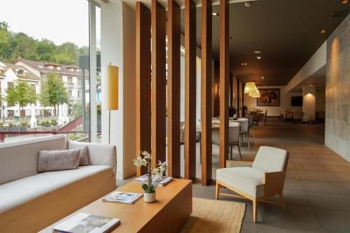 a living room with a couch and a table at Blau Hotel Las Caldas, a member of Radisson Individuals in Las Caldas