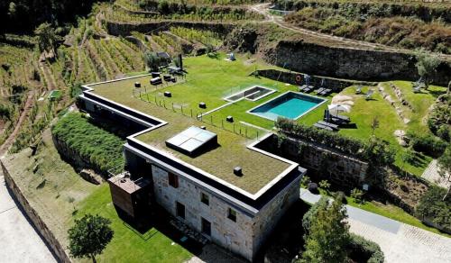 an aerial view of a building with a grass roof at Douro Country House in Cinfães