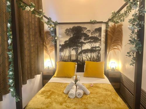 a bedroom with a bed with two stuffed animals on it at Romantic getaway with Balneo Centre Lorient in Lorient
