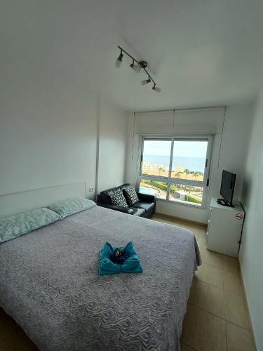 a bedroom with a bed with a blue bow on it at Super Penthouse Ocean View in San Miguel de Abona
