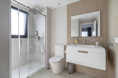a bathroom with a toilet and a sink and a shower at Iconic Sea View in Gran Alacant
