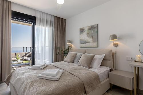 a bedroom with a bed with a view of the ocean at Iconic Sea View in Gran Alacant