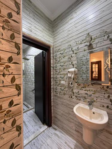 a bathroom with a toilet and a sink at TriPyramids Suites in Cairo