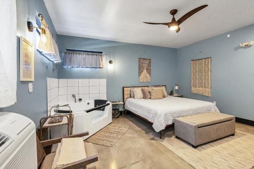 a bedroom with a bed and a tub and a sink at Relaxing king suite with jacuzzi and pool in Pacific