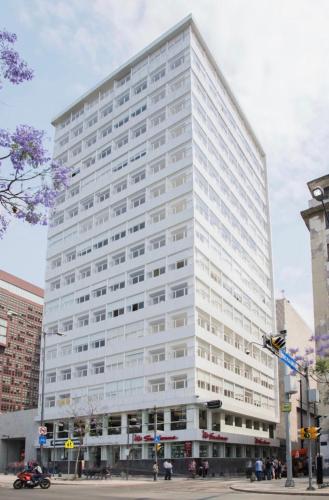 a large white building on a city street at Alameda central, Juárez 52 in Mexico City