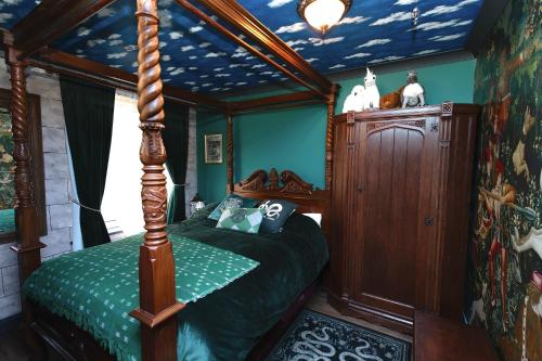 a bedroom with a canopy bed in a house at Quidditch Quarters Themed Property in Garston