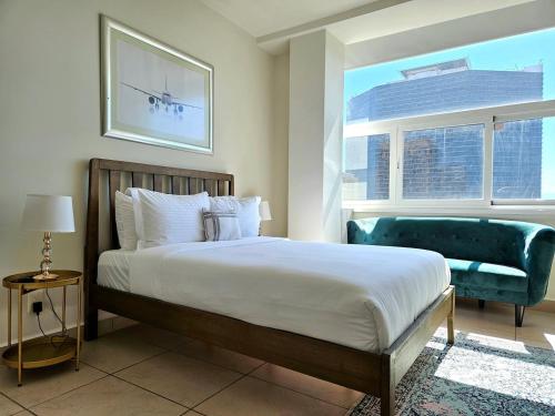 a bedroom with a bed and a chair and a window at Alameda central, Juárez 52 in Mexico City