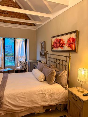 a bedroom with a large bed and a window at Winner in the Overberg in Bredasdorp