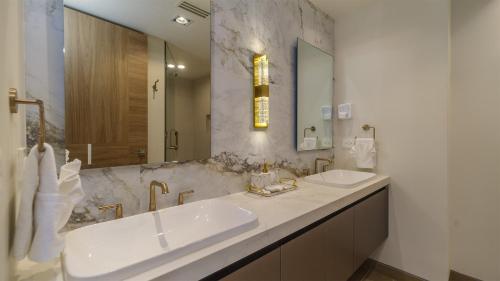a bathroom with two sinks and a large mirror at Elegant Beachfront Getaway with Unmatched Views in Puerto Peñasco
