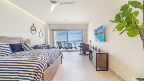 a bedroom with a bed and a view of the ocean at Elegant Beachfront Getaway with Unmatched Views in Puerto Peñasco