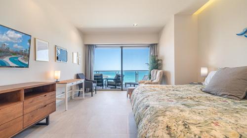 a hotel room with a bed and a desk with a view at Elegant Ocean Getaway Designed for Relaxation and Luxury in Puerto Peñasco