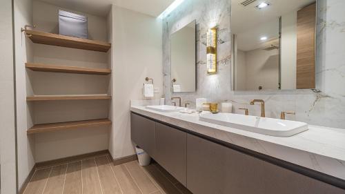 a bathroom with two sinks and a large mirror at Elegant Ocean Getaway Designed for Relaxation and Luxury in Puerto Peñasco