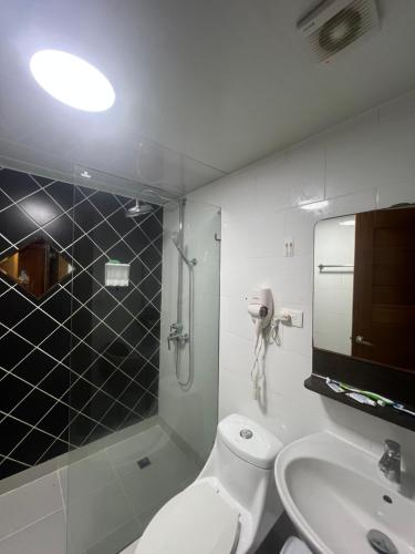 a bathroom with a toilet and a sink and a shower at STEPS TO THE BEACH 2 Stunning condo 4 min walk to Bibijagua Beach and Catamarans in Punta Cana