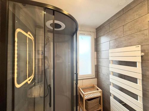 a shower with a glass door in a bathroom at Le Robespierre - Parking privé - 5min gare in Reims