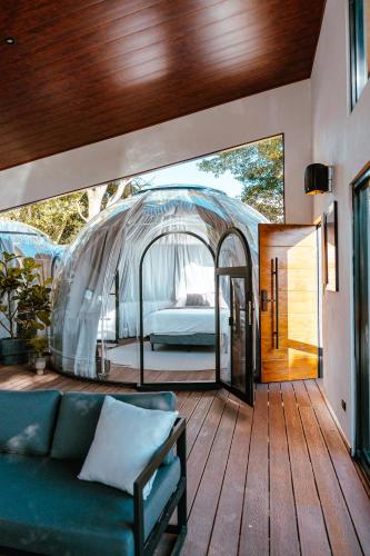 a living room with a couch and a bed in a tent at AMANI Casa Suite in San Rafael